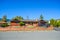 Residential house with red brick wall with black truck parked on driveway