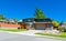 Residential house with wide garage door and concrete driveway