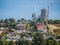 Residential houses in Melbourne`s suburb with new apartment buildings under construction in distance.