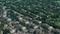 Residential houses in suburbs near city . Sunny day time. Wide above aerial view.