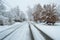 Residential neighborhood city street in severe snowstorm long street view