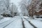 Residential neighborhood city street in severe snowstorm short street view