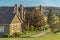 Residential scenery with pathways and grassy field in front of charming houses