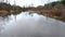 Residential street flooded by a heavy rainfall, road closed and completely covered with water, wetlands on both sides of street