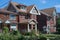 Residential street with large detached brick houses