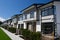 Residential townhouses on blue sky background on sunny day. External facade of a row of colorful modern urban townhouses.brand new