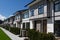 Residential townhouses on blue sky background on sunny day. External facade of a row of colorful modern urban townhouses.brand new