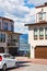 Residential townhouses with scenery view on a lake and mountains. Townhomes with wide garage door and cars parked in front.