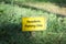 Residents parking only yellow sign on green grass