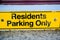 Residents only yellow parking sign on wall