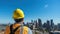 Resilient Construction Worker in Yellow Hardhat Overlooking Cityscape