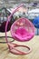 Resin pink wicker hanging rocking chair