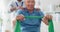 Resistance band, physical therapy and old man with physiotherapist, muscle training and strength with senior care