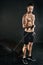 Resistance is NOT futile. Studio shot of a shirtless young man working out with a resistance band against a dark