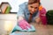 Resolute accurate hard-working woman wiping dust from wooden table