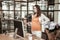 Resolute long-haired office worker standing in front of the computer