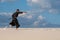 Resolute man practicing Japanese martial arts in desert
