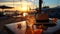 resort beach at sunset,glass of sparkling orange water on wooden table top on beach