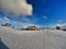 Resort buildings under an amazing heavy cloudscape with perfect snow for skiing