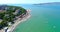The Resort Of Gelendzhik. Flying over the beach from a bird`s eye view. A pebbly beach, rows of sun umbrellas and sun