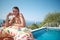 Resort holidays and travel, relaxation in luxurious house young happy slender woman tourist with air donut resting near swimming