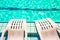 Resort hotel swimming pool background wallpaper pattern top view with empty copy space for your text here white deckchairs