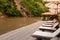 Resort style beach daybeds and umbrellas by river Kwai, Kanchanaburi, Thailand