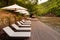 Resort style beach daybeds and umbrellas by river Kwai, Kanchanaburi, Thailand