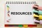 the resources text is written on a white notepad. Enterprise resource planning concept. Business structure and many