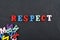 RESPECT word on black board background composed from colorful abc alphabet block wooden letters, copy space for ad text