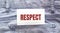 RESPECT words on a white paper stuck out from jeans pocket. Business concept