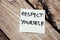 Respect Yourself -Hand written yellow sticky note on the wooden background