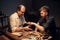 A respectable elderly shoemaker conducts a master class for a young boy on making shoes by hand in a special workshop.