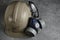 Respirator, goggles and miner protective helmet on concrete floor.