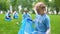 Responsible child volunteer collecting trash in garbage bag smiling on camera