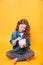 Responsible girl putting money into piggy bank for future saving