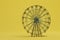 rest in the amusement park. Ferris wheel on a yellow background. 3D render