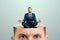 Rest for the brain, close-up of a man`s head inside a man in a business suit sitting in the lotus position. Creative background,