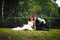 Rest on the green carpet - wedding couple sit on the ground