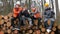 Rest group workers sawmill. They sit on stacked logs Pours tea, smokes