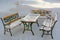 Rest place on a frosty winter day, benches and a table covered with white fluffy snow