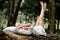 Rest, relaxation in the forest. A woman lies on a pillow on a tree surrounded by green foliage