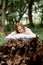 Rest, relaxation in the forest. A woman lies on a pillow on a tree surrounded by green foliage