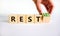 Rest and restart symbol. Businessman turns a wooden cube and changes the word rest to restart. Beautiful white table, white