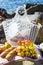 Rest by the sea with grapes, apples, pears, baguettes, wine and a basket on the coverlet