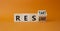 Restart and Resume symbol. Turned wooden cubes with words Resume and Restart. Beautiful orange background. Business and Restart