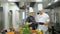 Restaurant chef makes a verification in kitchen. Interacting to head chef in commercial kitchen