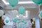 Restaurant decorated with white and turquoise balloons