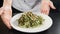 Restaurant food. chef presenting plate with delicious italian pasta in kitchen. Close-up. Restaurant food cooking and