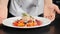 Restaurant food concept. chef presenting food plate with delicious flambe style fruit dessert. Close-up. Restaurant food